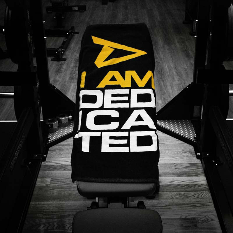 Towel with I Am Dedicated logo on bench